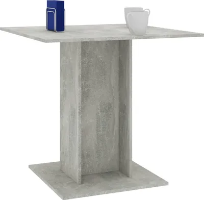 A concrete-effect table with two white mugs and a blue object on top.
