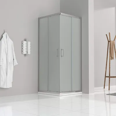 A modern bathroom with a shower cabin, a bathrobe hanging on the wall, and a wooden coat rack.