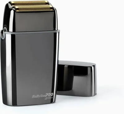 A close-up studio shot of a gunmetal gray electric shaver with gold foil blades, placed on a white background. The shaver's cap is detached and placed to the right of the main unit.
