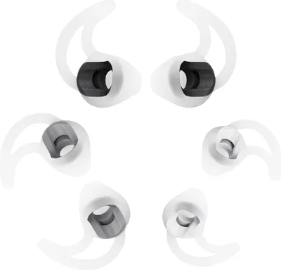 A set of six white silicone earbud tips with black inner components, arranged in a circular pattern against a white background.