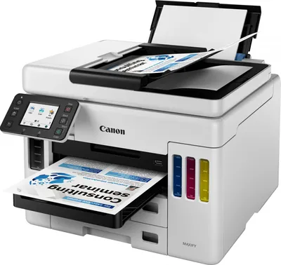 A white Canon MAXIFY GX 7050 multifunction printer is shown from a slightly elevated front-left angle. The printer has a paper output tray extended with a document inside, and the scanner lid is open with documents inside. The printer has a color touchscre