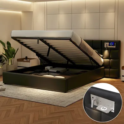 A modern bedroom with a black upholstered storage bed with its hydraulic lift mechanism open, revealing storage space underneath. The bed has a tufted headboard with integrated lighting and a charging station.