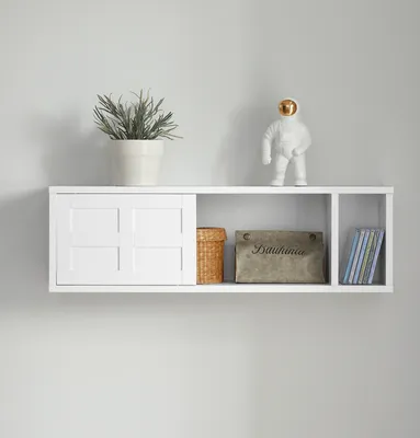 A white wall-mounted shelf with various items on it.