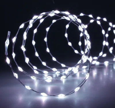 A coiled string of white LED lights against a dark background.