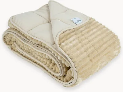 A folded beige weighted blanket with a quilted top and a ribbed plush underside.