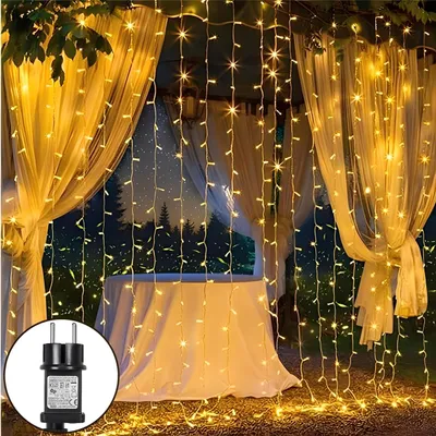 A decorated outdoor space with string lights and curtains, suggesting a festive or romantic atmosphere.