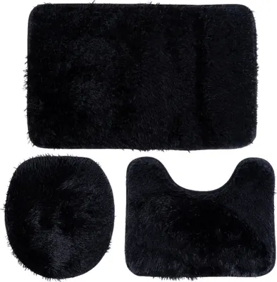 A set of three black bath mats arranged on a white background.