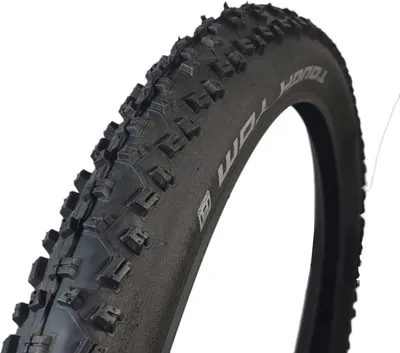 A close-up of a black bicycle tire with visible tread patterns and text on the sidewall.
