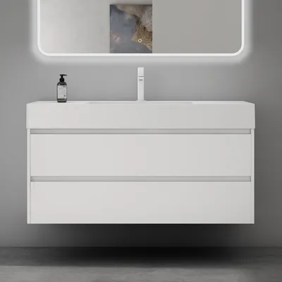 A modern white bathroom vanity with two drawers, mounted on a gray wall.