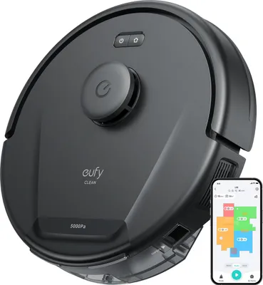 A black robot vacuum cleaner is shown from a top-down diagonal angle, with a smartphone displaying its map next to it.