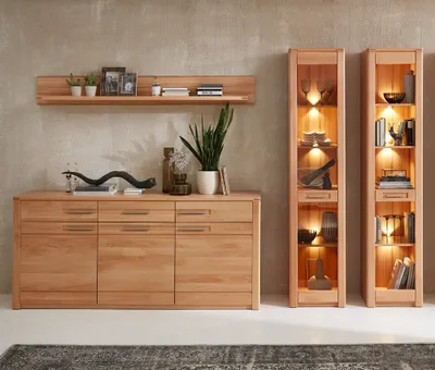 A wooden sideboard and two glass display cabinets are shown in a room with a textured wall.