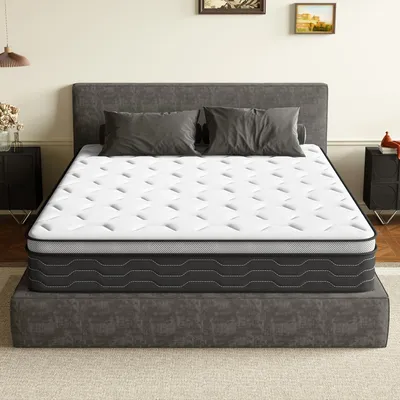 A mattress is displayed on a bed frame in a bedroom setting.