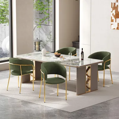 A dining room setting with a marble-topped dining table and four green upholstered chairs with gold legs.
