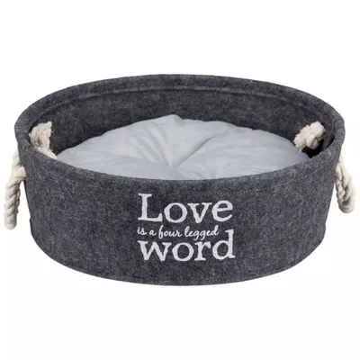 A round, gray felt pet bed with white rope handles and a light gray cushion inside. White text is embroidered on the front of the bed.