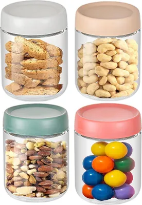 Four glass jars filled with different food items, arranged in a 2x2 grid.