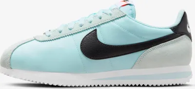 A side view of a single Nike Cortez sneaker.