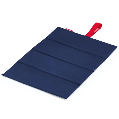 A folded blue seat pad with a red loop on a white background.