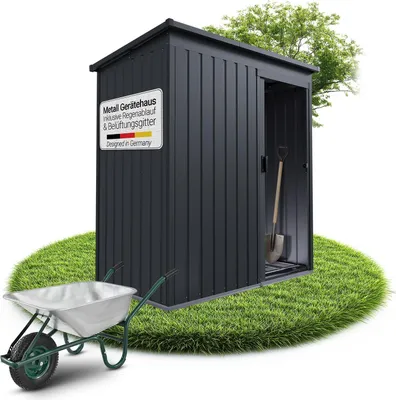 A dark gray metal garden shed is shown on a circular patch of grass, with a wheelbarrow in the foreground and a shovel inside the shed.