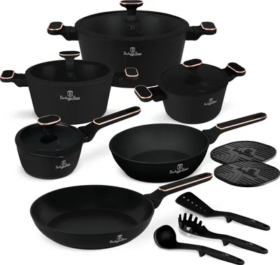 A collection of black cookware with rose gold accents, arranged on a white background.