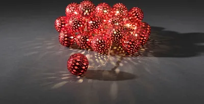 A cluster of red, decorative LED lights with a single light in the foreground.