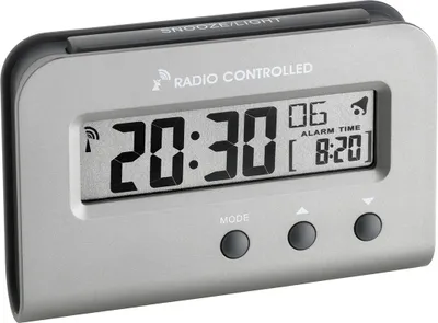 A digital alarm clock is shown against a light gray background.