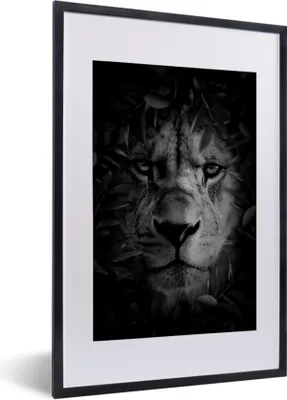 Produktbild von MuchoWow® Gerahmtes Poster Nahaufnahme eines Löwen mit Blättern im Dschungel - schwarz und weiß 40x60 cm - Poster mit Schwarzem Bilderrahmen Wandposter Rahmen Foto Bilder - Poster in Rahmen