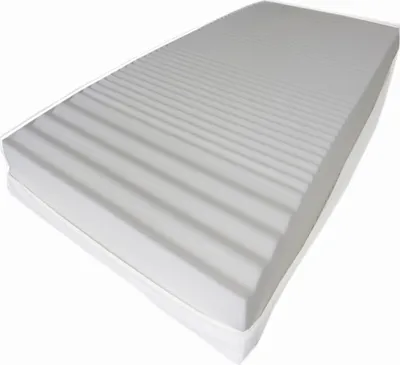 A mattress with a ribbed surface and a white cover, shown from a diagonal angle on a white background.