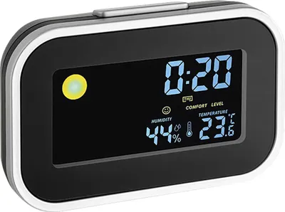 A digital alarm clock displaying the time, humidity, and temperature.
