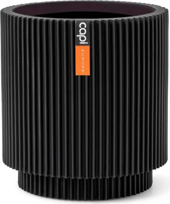 A black ribbed cylindrical planter with an orange and white label on the front.