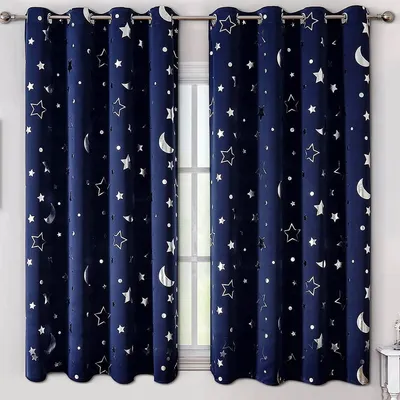 A pair of dark blue curtains with silver stars and moon cutouts hanging in a window.