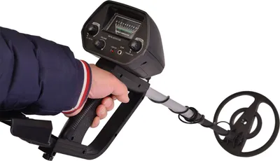 A hand holding a metal detector against a white background.