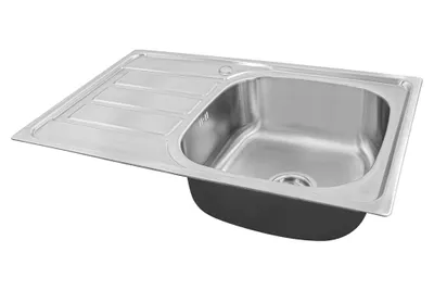 A stainless steel kitchen sink with a drainboard, shown from a diagonal angle against a white background.