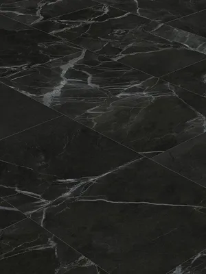 A close-up view of black marble-look vinyl flooring tiles.
