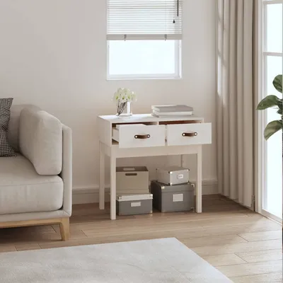 A console table with drawers and storage boxes underneath, next to a sofa and a window with blinds.