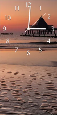 Produktbild von Wallario Design Wanduhr Strand am Abend - Seebrücke am Ostseebad Heringsdorf aus Echtglas, Größe 30 x 60 cm