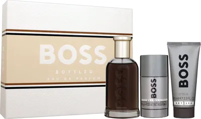 A product shot of a perfume set including a bottle, deodorant stick, and shower gel, presented with its packaging.