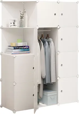 A white modular wardrobe with clothes hanging inside and books on a shelf.