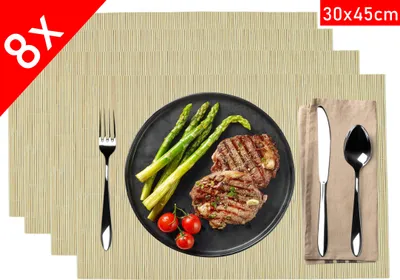 A set of placemats is displayed with a plate of food and cutlery on one placemat.