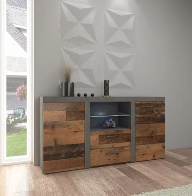 A modern living room with a sideboard against a textured wall, next to a window.