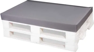 A gray cushion on a white wooden pallet.