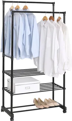A black metal and plastic garment rack with three shelves, holding several light blue and white shirts, a white box, and a pair of beige shoes.