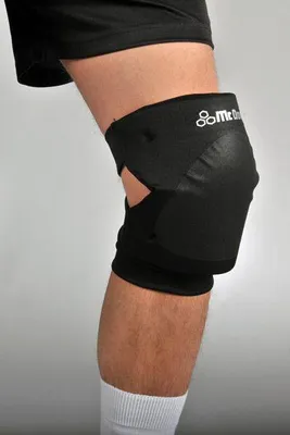 A close-up of a person's knee wearing a black knee brace.