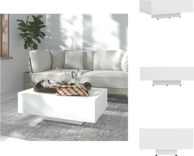 A white coffee table is placed in front of a sofa in a living room.