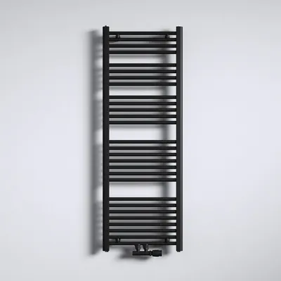 A black radiator is mounted on a white wall.