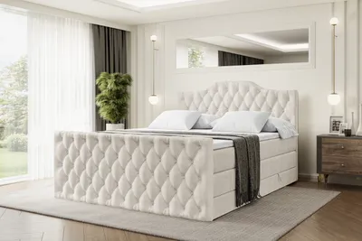 A bedroom scene with a large tufted bed as the focal point.