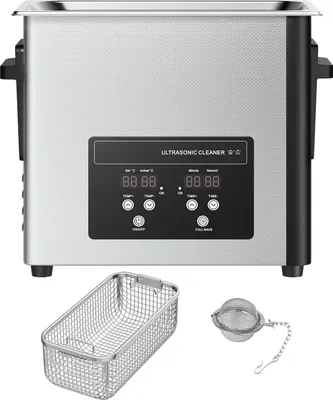 A silver ultrasonic cleaner with a black control panel and digital displays, shown with a metal basket and a tea infuser.