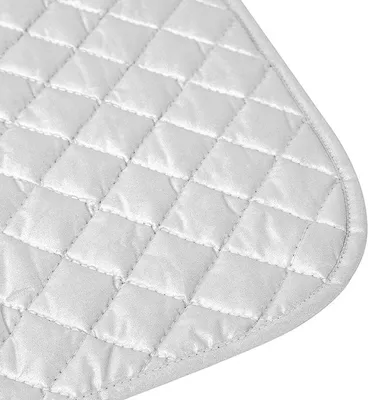 A close-up view of a quilted white fabric surface with a rounded corner.