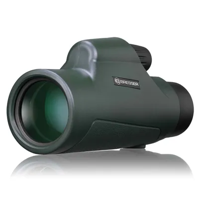 A dark green monocular is shown against a white background.