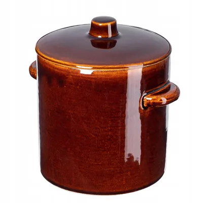 A brown ceramic pot with a lid and handles, isolated on a white background.