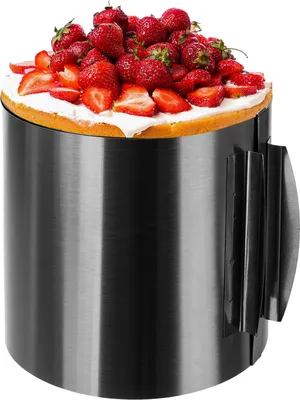A cake decorated with strawberries inside a cake ring.